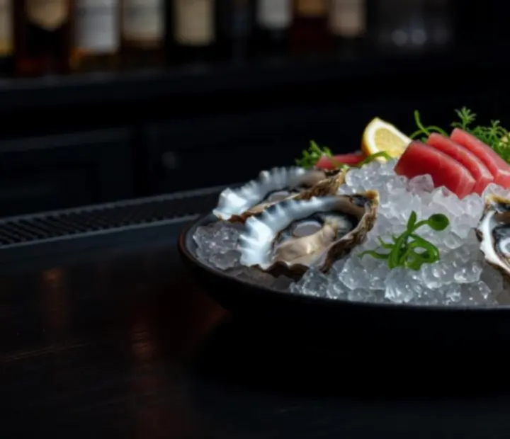 Assorted oysters and raw bar seafood on ice with citrus at Fortune & Fork